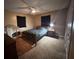 Cozy bedroom featuring dark curtains and comfortable furnishings at 2657 Joel Johnson Rd, Lillington, NC 27546