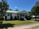 Quaint one-story home with a green metal roof and lush green lawn at 2657 Joel Johnson Rd, Lillington, NC 27546