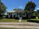 Charming single-story home featuring a green metal roof and well-manicured landscaping at 2657 Joel Johnson Rd, Lillington, NC 27546