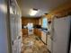 Functional kitchen featuring wood cabinets and white appliances at 2657 Joel Johnson Rd, Lillington, NC 27546