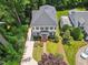 An aerial view of a two-story home featuring manicured landscaping, black shutters, and mature trees at 2725 Rosedale Ave, Raleigh, NC 27607