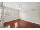 Inviting bedroom with hardwood floors, two bright windows, and a ceiling fan for added comfort at 2725 Rosedale Ave, Raleigh, NC 27607