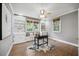 Bedroom with built-in shelves, hardwood flooring, and large windows providing natural light and scenic views at 2725 Rosedale Ave, Raleigh, NC 27607