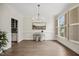 Elegant dining room with hardwood floors, stylish chandelier, and plantation shutters at 2725 Rosedale Ave, Raleigh, NC 27607