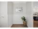 Bright foyer with wainscoting, hardwood floors, and a decorative wall mirror for added elegance at 2725 Rosedale Ave, Raleigh, NC 27607