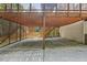 Expansive garage, partially screened, with adjacent stairway leading to the main level at 2725 Rosedale Ave, Raleigh, NC 27607