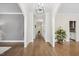 Hallway featuring hardwood floors, white trim, neutral paint, and ample natural light at 2725 Rosedale Ave, Raleigh, NC 27607