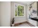 Light hallway with hardwood floors, decorative wall art, and a view of the outdoors at 2725 Rosedale Ave, Raleigh, NC 27607