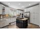 Modern kitchen featuring white cabinets, granite countertops, and a kitchen island at 2725 Rosedale Ave, Raleigh, NC 27607