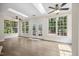 Bright living room with hardwood floors, skylights, and French doors to deck at 2725 Rosedale Ave, Raleigh, NC 27607
