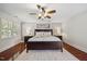 Well-lit main bedroom featuring hardwood floors and a comfortable queen-sized bed at 2725 Rosedale Ave, Raleigh, NC 27607