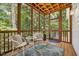 Relaxing screened porch with cozy seating and a scenic view of the trees and nature at 2725 Rosedale Ave, Raleigh, NC 27607