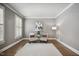Charming sitting room with a decorative rug, hardwood floors, and shutters at 2725 Rosedale Ave, Raleigh, NC 27607