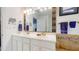 Bright and airy bathroom features a double sink vanity with gold fixtures and decorative mosaic backsplash at 2816 Shepard School Rd, Zebulon, NC 27597