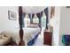 Cozy bedroom featuring a four-poster bed, reading lamp, and bright natural lighting at 2816 Shepard School Rd, Zebulon, NC 27597