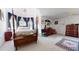Expansive bedroom with neutral carpet, a four-poster bed and an adjacent vanity area at 2816 Shepard School Rd, Zebulon, NC 27597