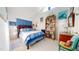 Cozy bedroom features vaulted ceilings, built-in bookshelf, and blue accents, creating a relaxing retreat at 2816 Shepard School Rd, Zebulon, NC 27597