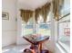 Bright breakfast nook with an elaborate wood table, detailed trim and curtains at 2816 Shepard School Rd, Zebulon, NC 27597