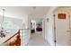 Bright hallway showcasing hardwood railing, unique glass block, and a glimpse into a tastefully decorated bedroom at 2816 Shepard School Rd, Zebulon, NC 27597