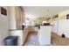 Well-lit kitchen with ample beige cabinetry and tile flooring at 2816 Shepard School Rd, Zebulon, NC 27597
