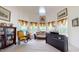 Living room featuring a piano, sofa, bookcase and plenty of natural light at 2816 Shepard School Rd, Zebulon, NC 27597