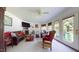 Bright living room with fireplace, TV, and multiple seating areas at 2816 Shepard School Rd, Zebulon, NC 27597