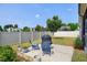 Backyard with a well manicured lawn, chairs, and a grill on a concrete patio at 29 Laurel Ln, Youngsville, NC 27596