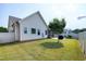 Spacious backyard with a lush lawn, tree, and partial view of the home's screened porch at 29 Laurel Ln, Youngsville, NC 27596