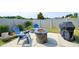 Cozy backyard patio featuring a fire pit, chairs, and a grill, perfect for outdoor entertaining at 29 Laurel Ln, Youngsville, NC 27596