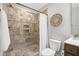 Bathroom featuring tiled shower with shelf, as well as a toilet and vanity at 29 Laurel Ln, Youngsville, NC 27596