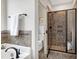 Modern bathroom with glass-enclosed shower and neutral tile surround at 29 Laurel Ln, Youngsville, NC 27596