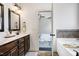 Bathroom featuring double vanity, granite countertops, and soaking tub at 29 Laurel Ln, Youngsville, NC 27596