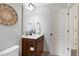 Bathroom featuring vanity with basin sink and nearby toilet at 29 Laurel Ln, Youngsville, NC 27596