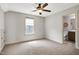Bedroom featuring a ceiling fan, window, and ensuite bath at 29 Laurel Ln, Youngsville, NC 27596