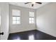 Bright bedroom with dark hardwood floors and lots of natural light from two windows at 29 Laurel Ln, Youngsville, NC 27596