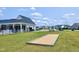 Community bocce court surrounded by lush green grass and residential buildings at 29 Laurel Ln, Youngsville, NC 27596