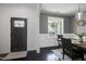 Dining room featuring gray walls, wainscoting, modern lighting, and a hardwood floor at 29 Laurel Ln, Youngsville, NC 27596