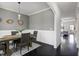 Dining room featuring gray walls, wainscoting, modern lighting, and a hardwood floor at 29 Laurel Ln, Youngsville, NC 27596