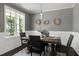 Dining room featuring gray walls, wainscoting, modern lighting, and a hardwood floor at 29 Laurel Ln, Youngsville, NC 27596