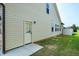Neutral colored home exterior with a door leading to the backyard at 29 Laurel Ln, Youngsville, NC 27596