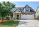 Charming home with a two-car garage, stone accents, and a well-manicured lawn at 29 Laurel Ln, Youngsville, NC 27596