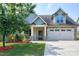 Charming home with a two-car garage, stone accents, and a well-manicured lawn at 29 Laurel Ln, Youngsville, NC 27596