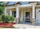 Inviting front porch with stone columns, a hanging light, and decorative welcome sign at 29 Laurel Ln, Youngsville, NC 27596