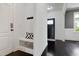 Hallway entry featuring bench seating, a coat rack, and hardwood floors at 29 Laurel Ln, Youngsville, NC 27596