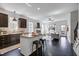 Open-concept kitchen with dark cabinets, granite countertops, an island, and stainless steel appliances at 29 Laurel Ln, Youngsville, NC 27596