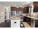 Modern kitchen features dark wood cabinetry, stainless steel appliances, and a granite countertop island with seating at 29 Laurel Ln, Youngsville, NC 27596
