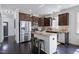 Modern kitchen features dark wood cabinetry, stainless steel appliances, and a granite countertop island with seating at 29 Laurel Ln, Youngsville, NC 27596
