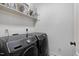 Laundry room with black Samsung washer and dryer, as well as overhead storage at 29 Laurel Ln, Youngsville, NC 27596