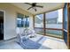 Relaxing screened porch featuring comfortable rocking chairs and an outdoor ceiling fan at 29 Laurel Ln, Youngsville, NC 27596
