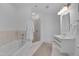 Bright bathroom featuring a soaking tub, glass shower, modern vanity, and sleek fixtures at 301 Fayetteville St # 2611, Raleigh, NC 27601